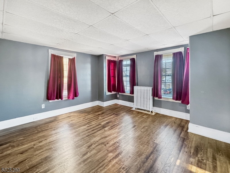 62 Summit Avenue, Unit B Phillipsburg, NJ 08865 - Photo 7 of 9 an empty room with wooden floor and windows