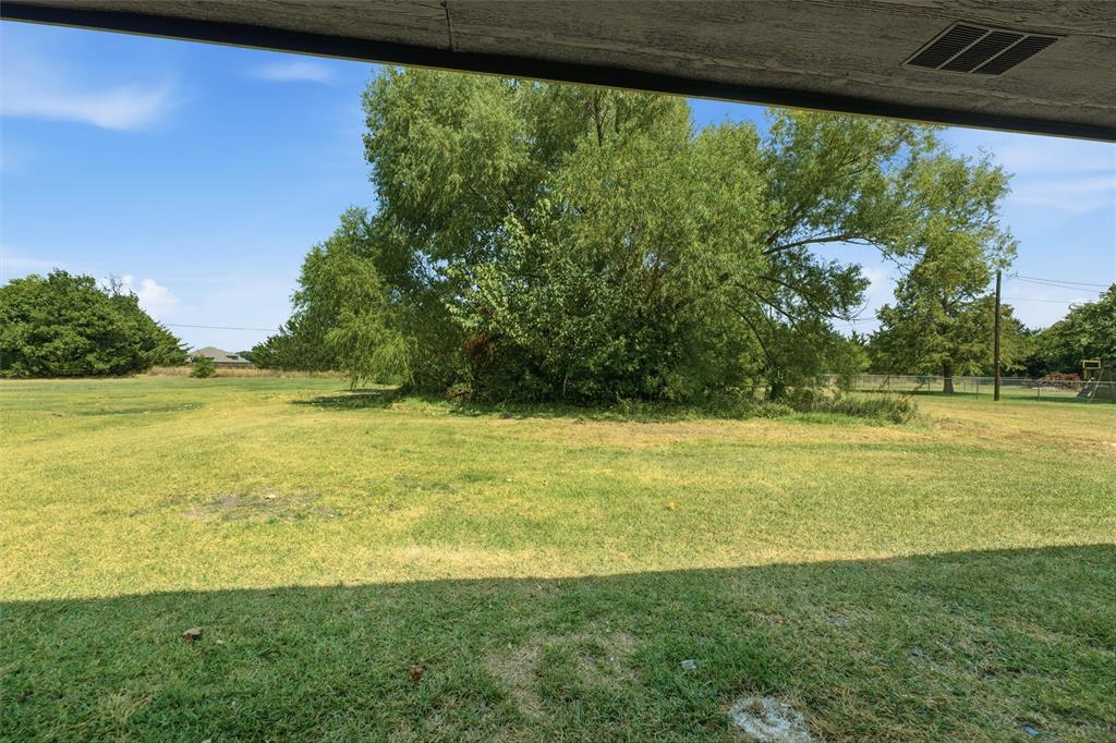 124 Prairie Creek Road Red Oak, TX 75154 - Photo 16 of 17 Expansive grounds featuring a manicured lawn with mature shade trees and open landscape