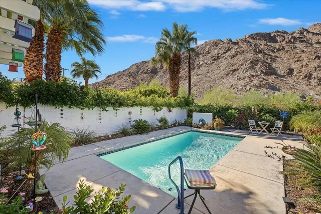 a view of a backyard with plants and patio