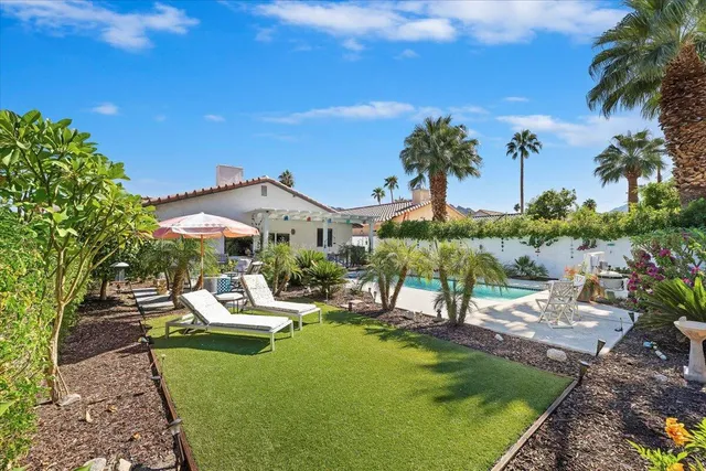 a view of a house with a backyard porch and sitting area