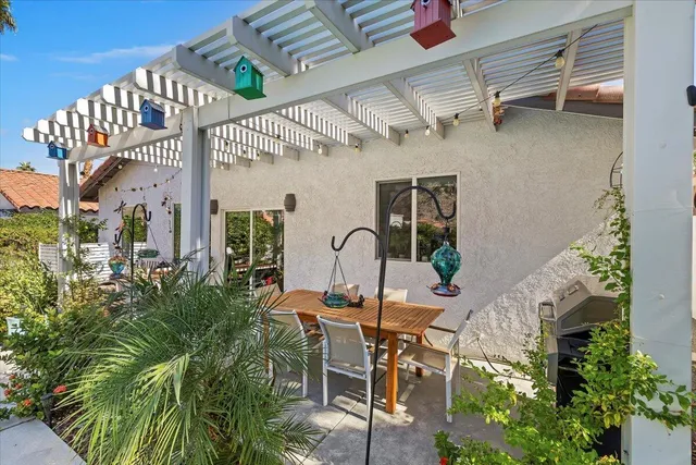 a view of a patio with table and chairs and potted plants