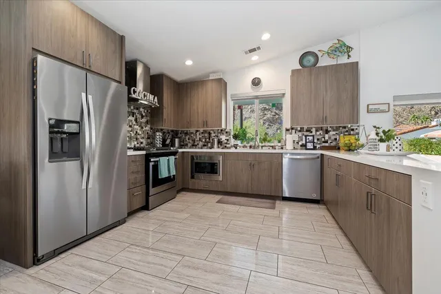 a view of a dining room with furniture and chandelier