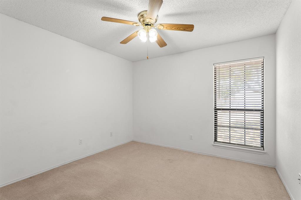 162 Warren Road Lorena, TX 76655 - Photo 27 of 39 Recessed window with blinds, overhead ceiling fan with light fixture, and neutral carpeting