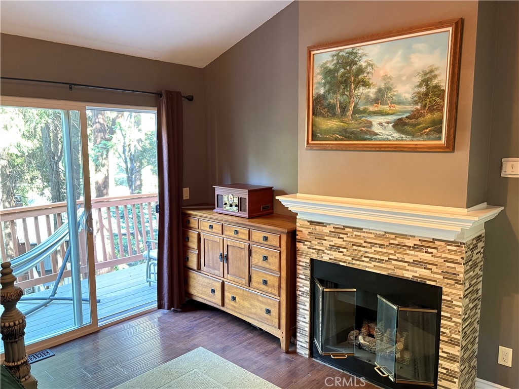 743 Woodland Road Crestline, CA 92325 - Photo 24 of 57 a living room with stainless steel appliances wooden floor and a fireplace