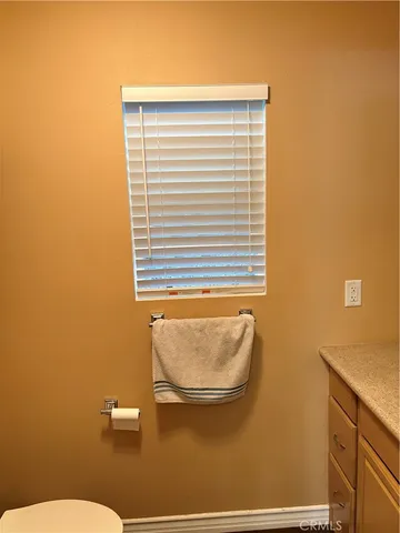 a bathroom with a granite countertop sink and a large mirror