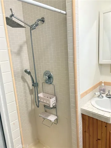 a bathroom with a granite countertop sink and a bathtub