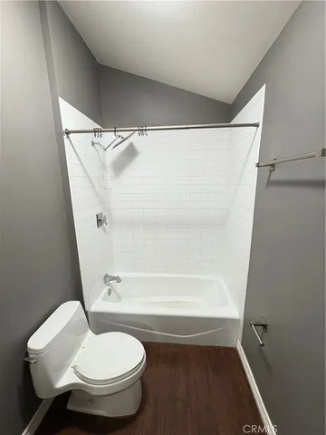 a bathroom with a granite countertop toilet sink and mirror