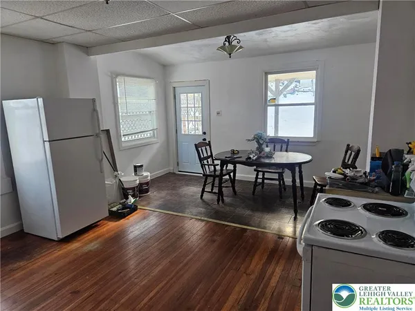 a dining room with furniture a window and wooden floor