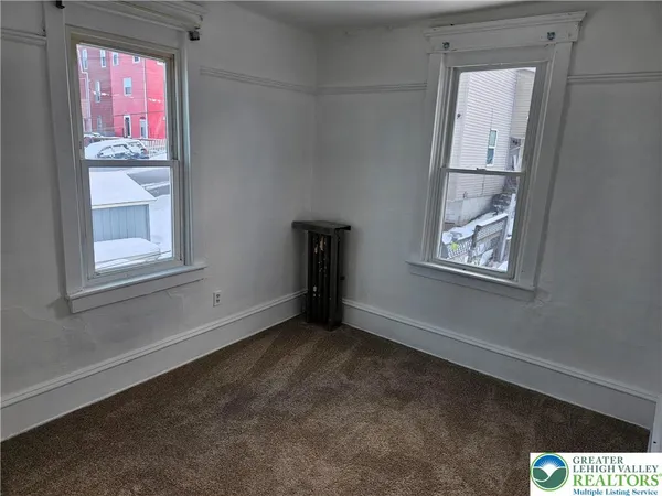 a view of an empty room with a window