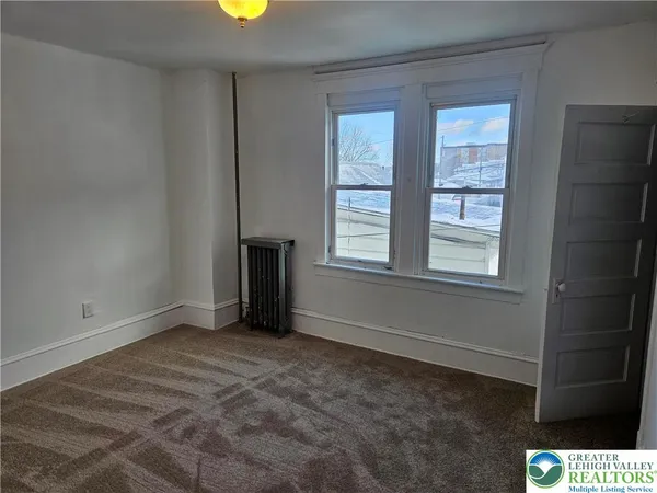 a view of an empty room with a window