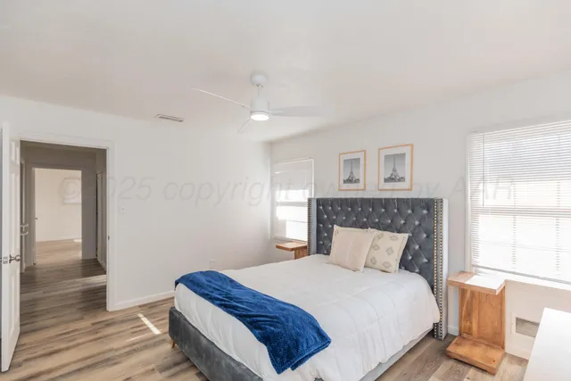 a bedroom with a bed and wooden floor