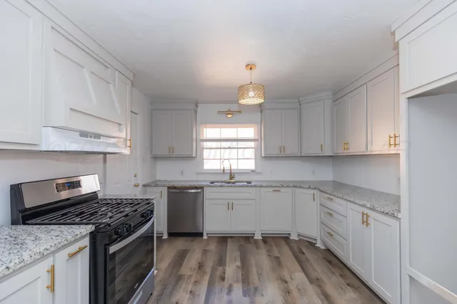 a kitchen with a sink stove and cabinets