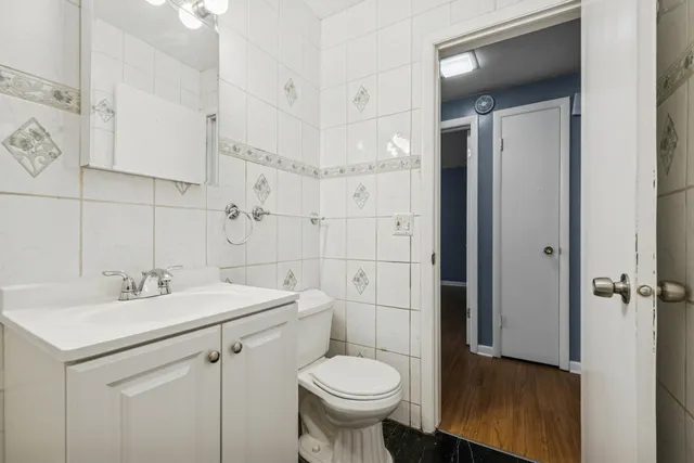 a bathroom with a toilet sink and mirror