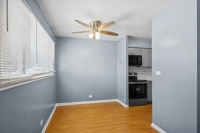 a view of kitchen with sink and refrigerator