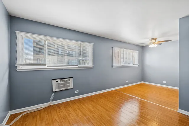 a view of a room with wooden floor and a window