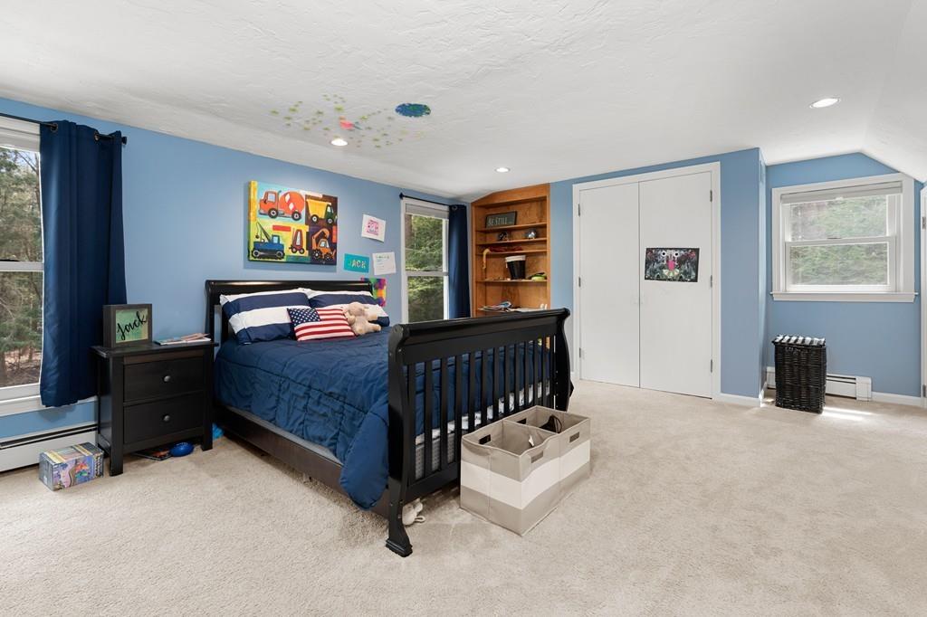 16 Standish Road Wayland, MA 01778 - Photo 15 of 22 a bedroom with a bed and a flat screen tv