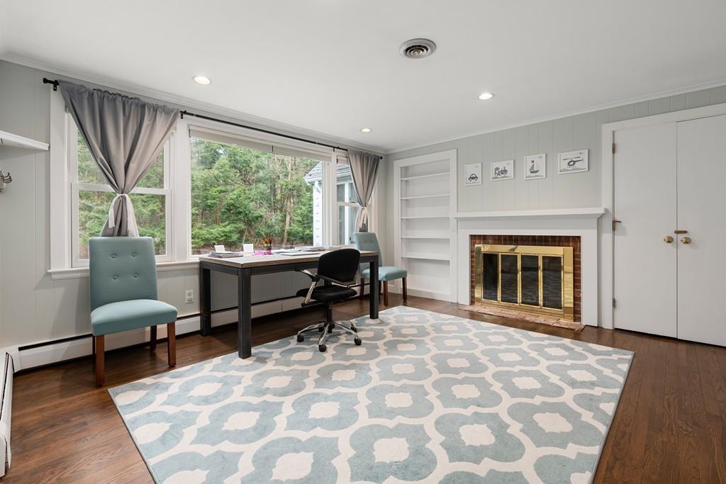 16 Standish Road Wayland, MA 01778 - Photo 16 of 22 a living room with furniture and a fireplace