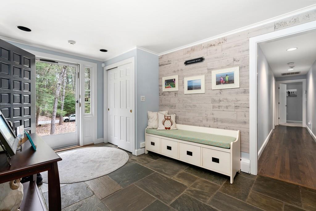 16 Standish Road Wayland, MA 01778 - Photo 2 of 22 a bathroom with a double vanity sink a mirror and a bathtub