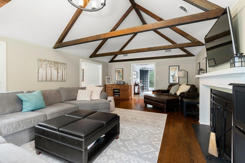 16 Standish Road Wayland, MA 01778 - Photo 5 of 22 a living room with furniture a fireplace and a flat screen tv