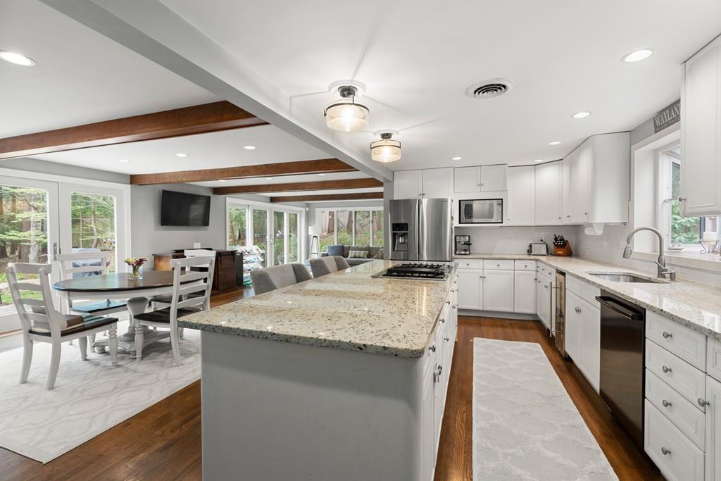 16 Standish Road Wayland, MA 01778 - Photo 7 of 22 a large kitchen with lots of counter space a sink appliances and a dining table