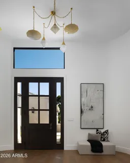 a view of a room with a chandelier furniture and windows