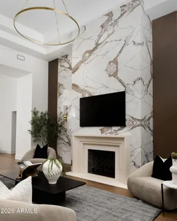 a living room with fireplace furniture and a flat screen tv
