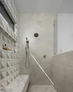 a bathroom with double vanity sinks and a mirror