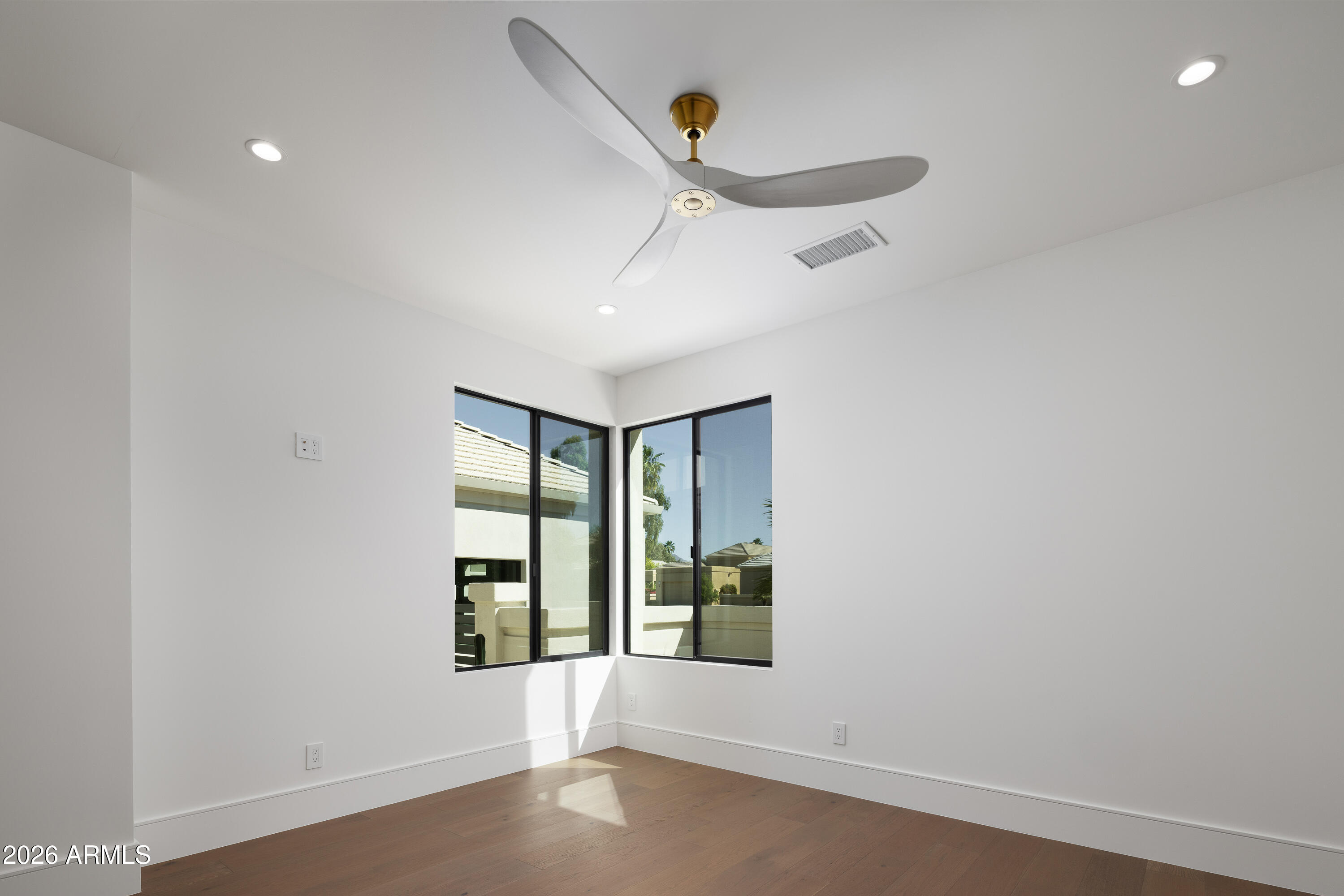 7878 East Gainey Ranch Road, Unit 14 Scottsdale, AZ 85258 - Photo 21 of 40 an empty room with windows and fan