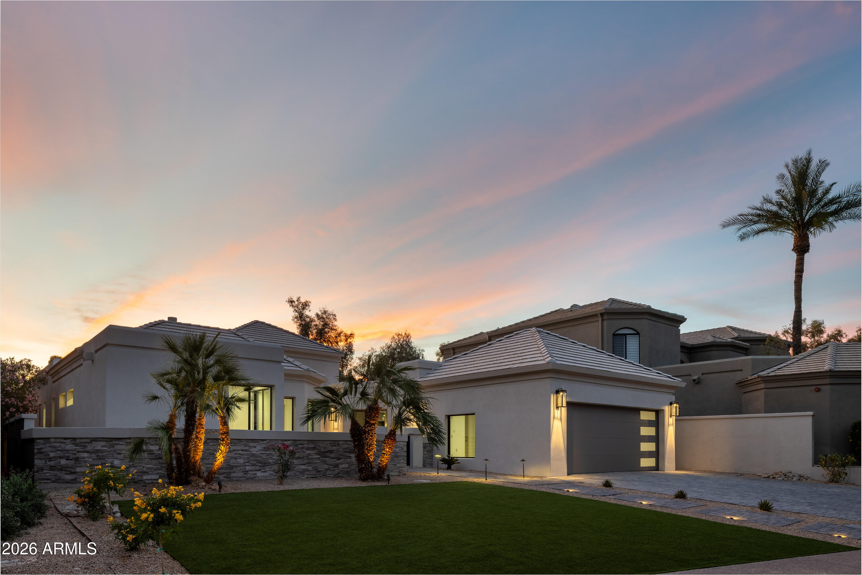 7878 East Gainey Ranch Road, Unit 14 Scottsdale, AZ 85258 - Photo 3 of 40 a view of a big house with a big yard and potted plants