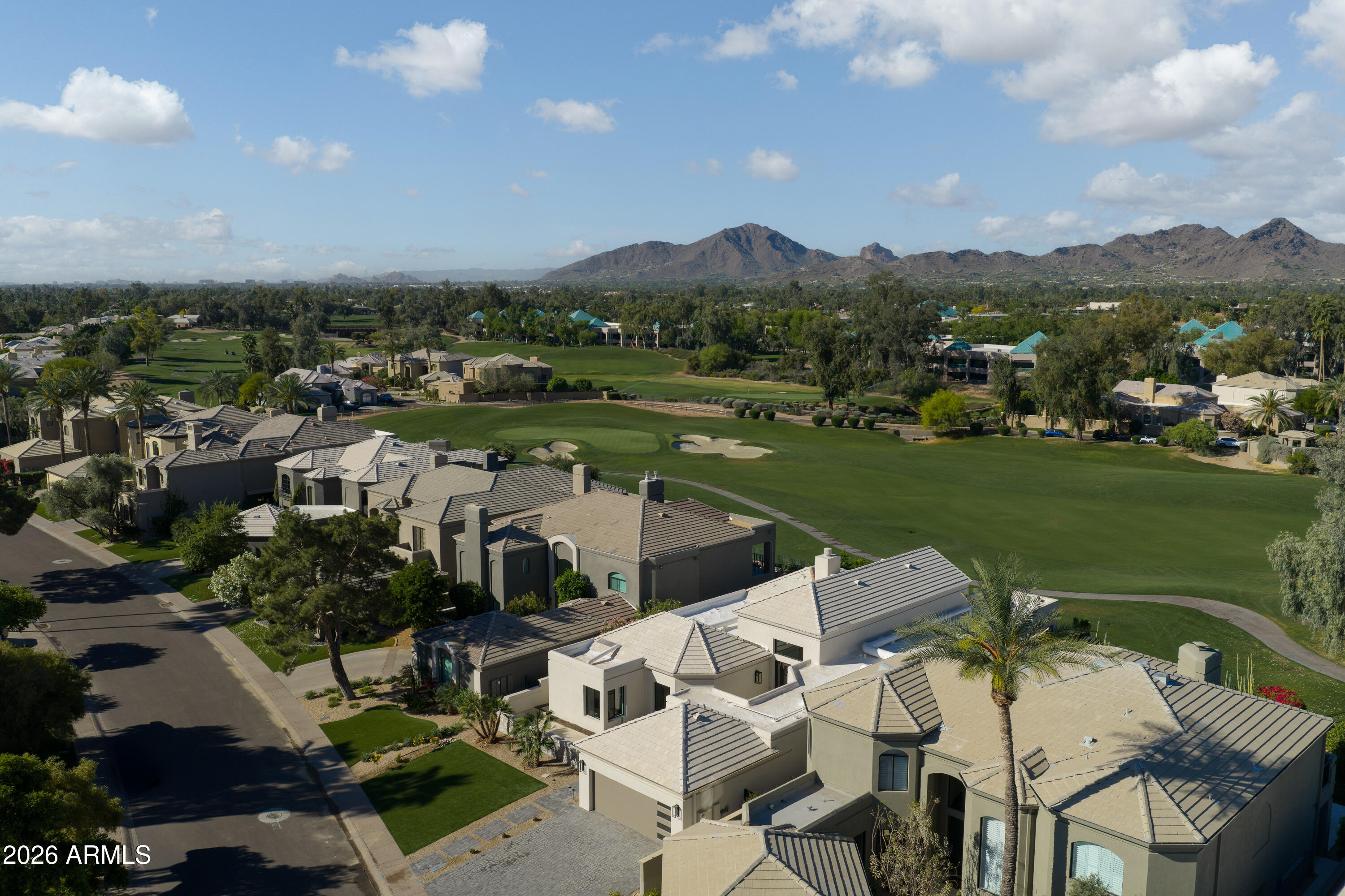 7878 East Gainey Ranch Road, Unit 14 Scottsdale, AZ 85258 - Photo 32 of 40 a view of a lake with a mountain in the background