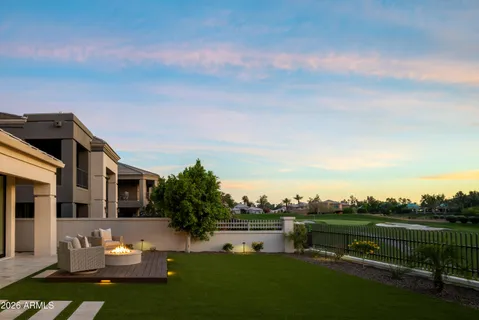 a view of a house with a garden and sitting area