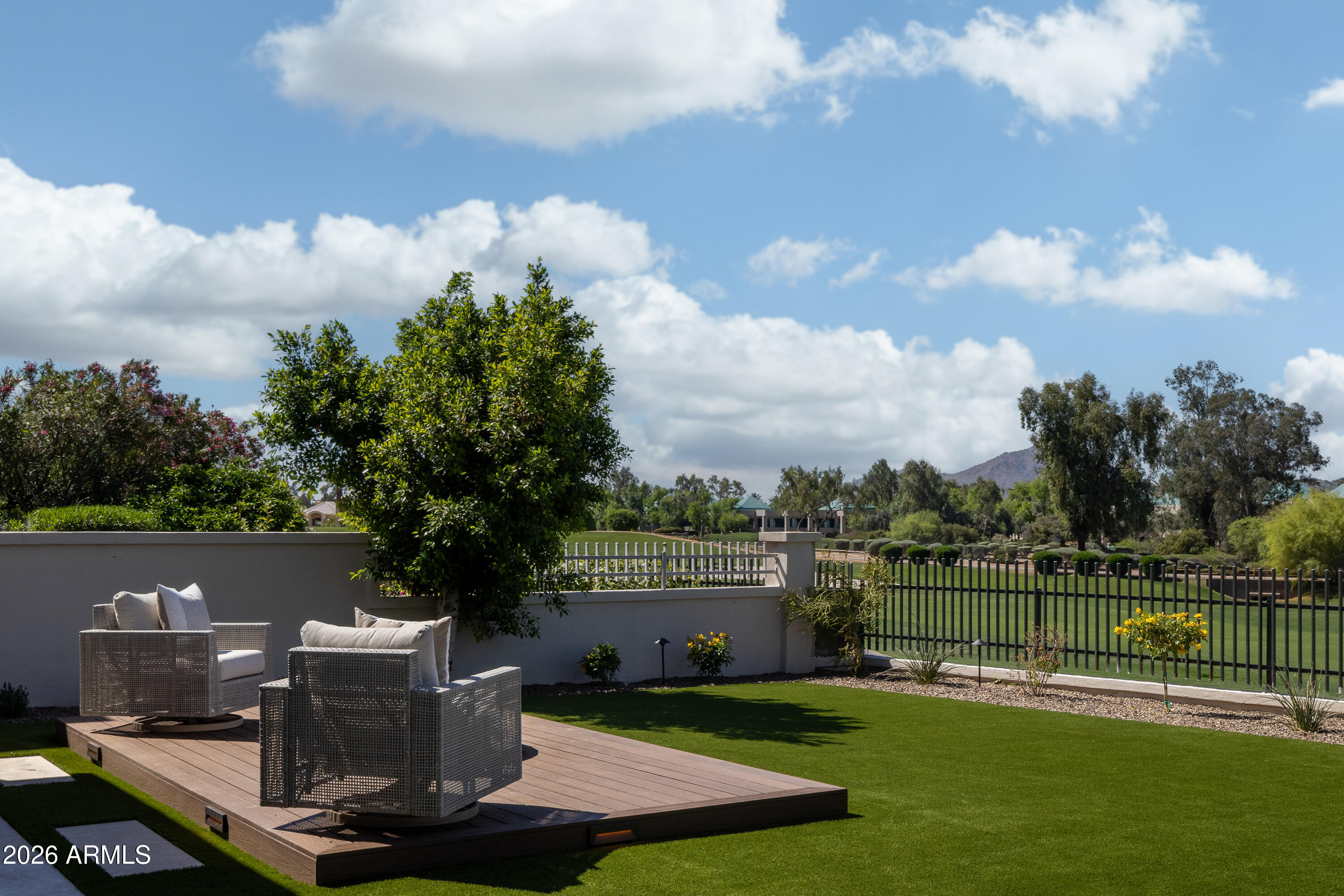 7878 East Gainey Ranch Road, Unit 14 Scottsdale, AZ 85258 - Photo 8 of 40 a view of a lake with a house in the background