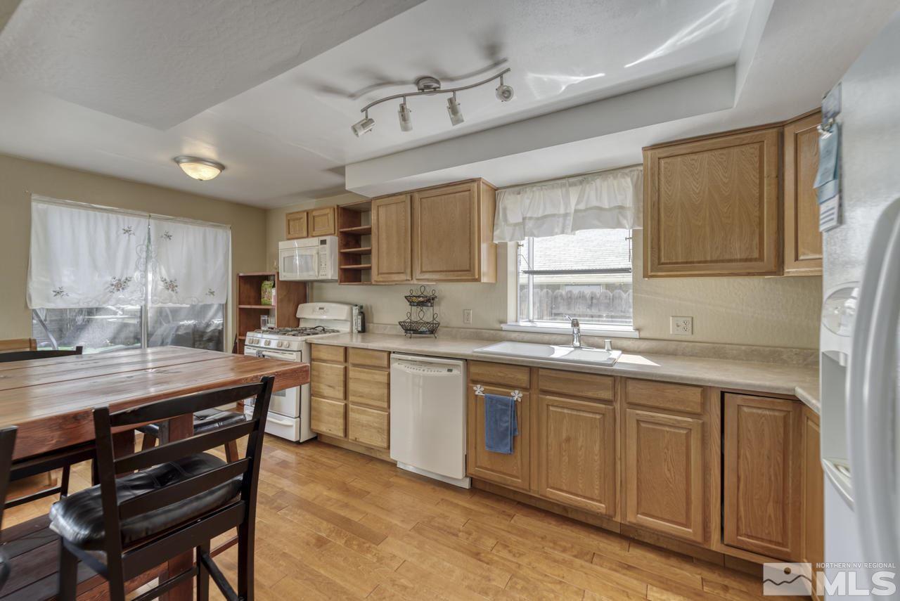 1296 Canyon Creek Road Reno, NV 89523 - Photo 11 of 32 a kitchen with a sink stove cabinets and wooden floor