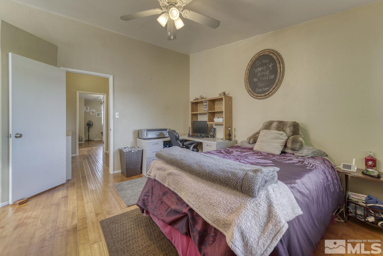 1296 Canyon Creek Road Reno, NV 89523 - Photo 12 of 32 a bedroom with a bed and a chandelier