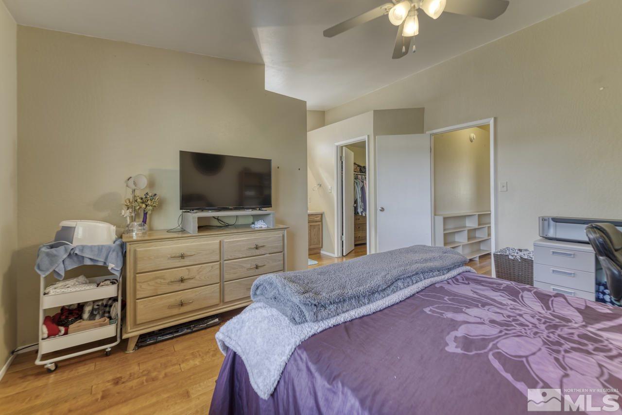 1296 Canyon Creek Road Reno, NV 89523 - Photo 13 of 32 a bedroom with a bed and a flat screen tv
