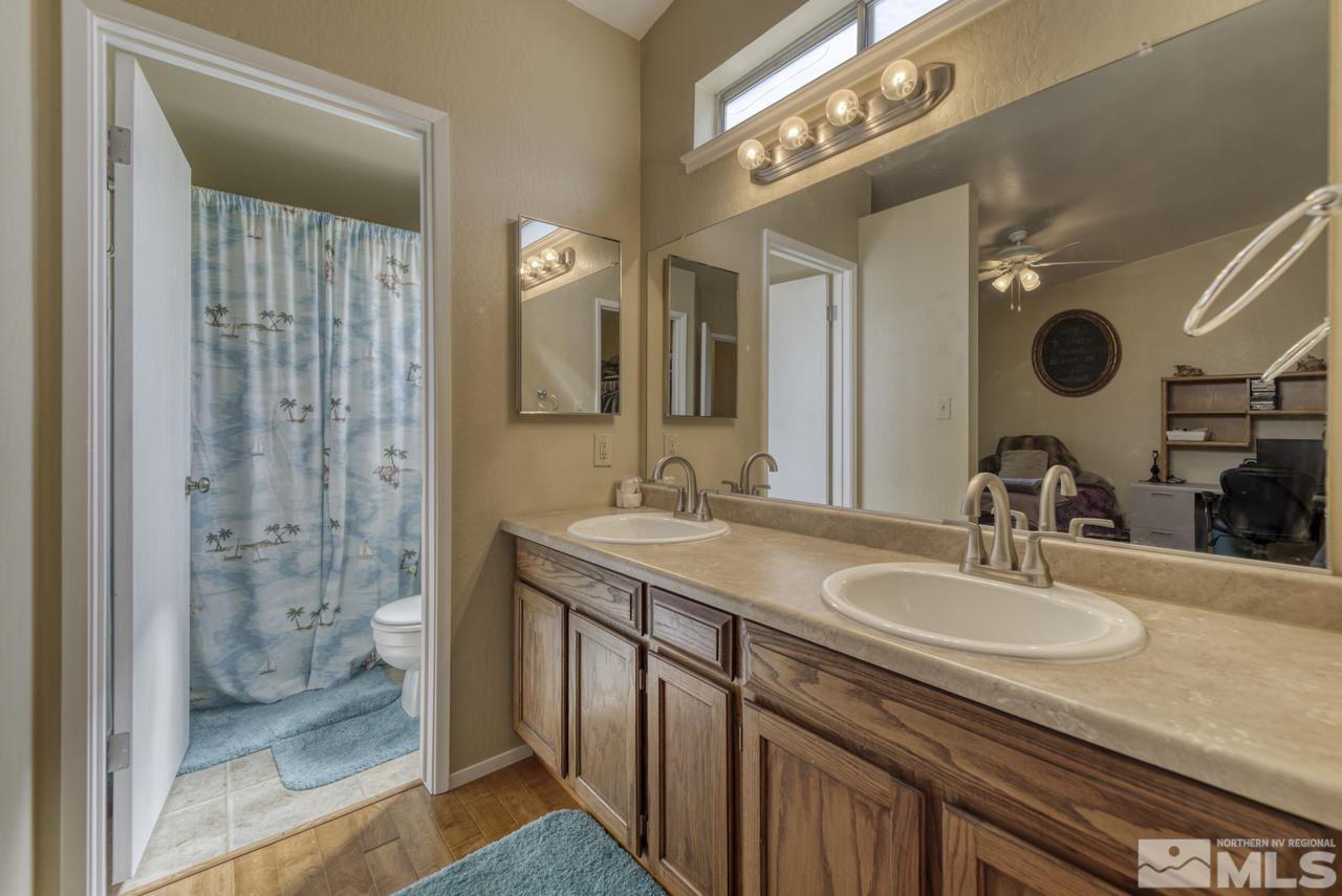 1296 Canyon Creek Road Reno, NV 89523 - Photo 14 of 32 a bathroom with a granite countertop sink a mirror and shower