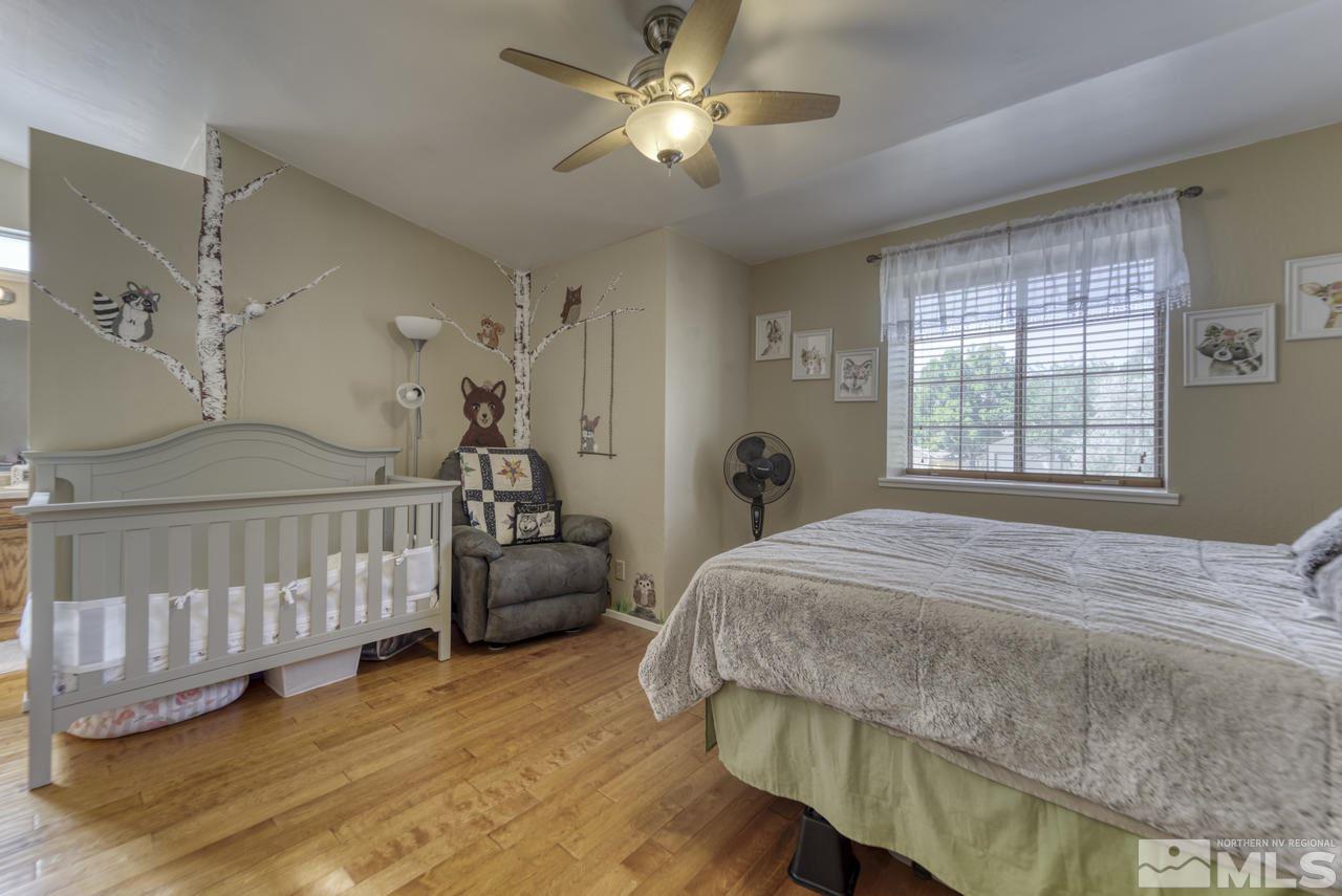 1296 Canyon Creek Road Reno, NV 89523 - Photo 15 of 32 a bedroom with a bed and a chandelier
