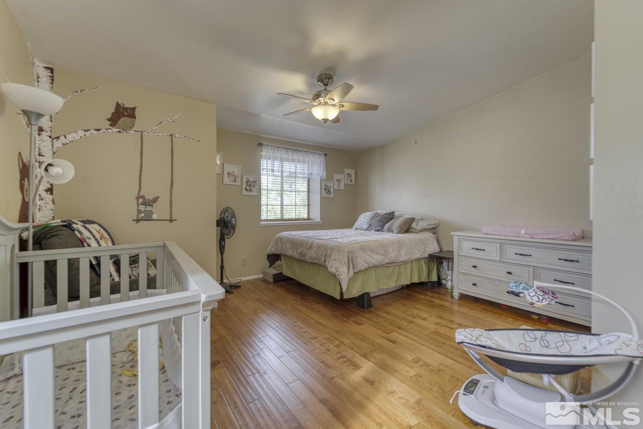 1296 Canyon Creek Road Reno, NV 89523 - Photo 16 of 32 a bedroom with a bed and a chandelier