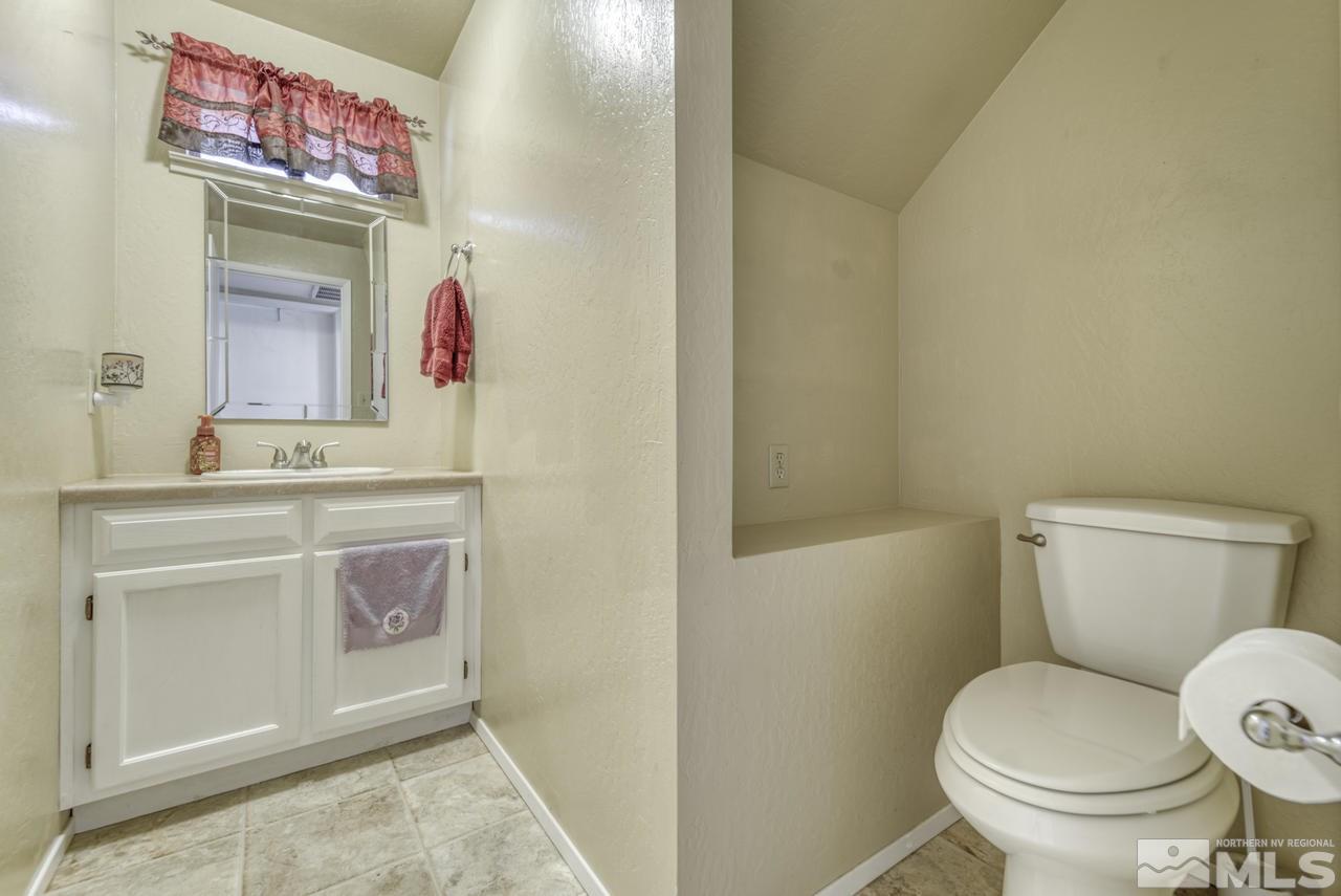 1296 Canyon Creek Road Reno, NV 89523 - Photo 18 of 32 a bathroom with a toilet sink and a mirror