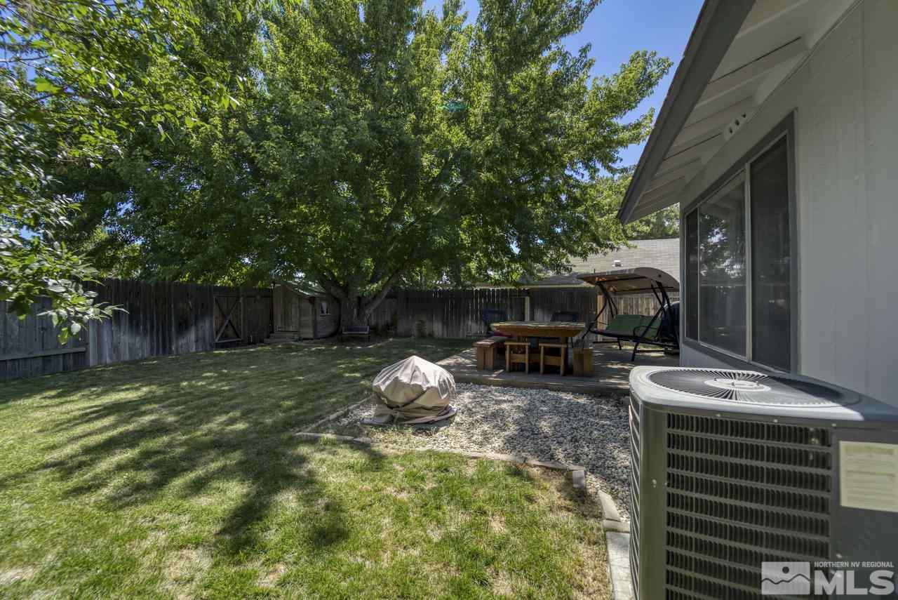 1296 Canyon Creek Road Reno, NV 89523 - Photo 25 of 32 a backyard of a house with barbeque oven table and chairs