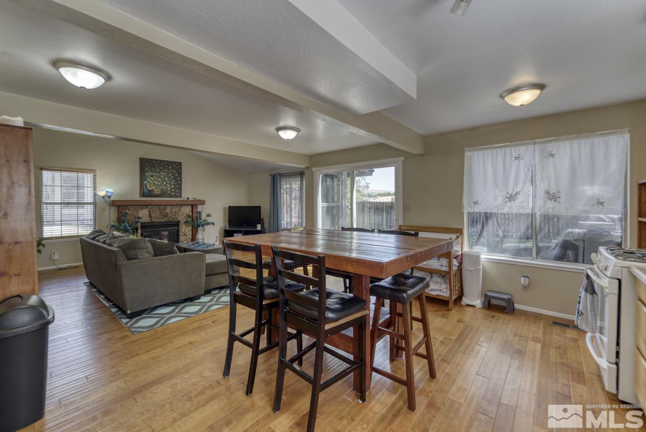 1296 Canyon Creek Road Reno, NV 89523 - Photo 28 of 32 a living room with furniture a wooden floor and a fireplace