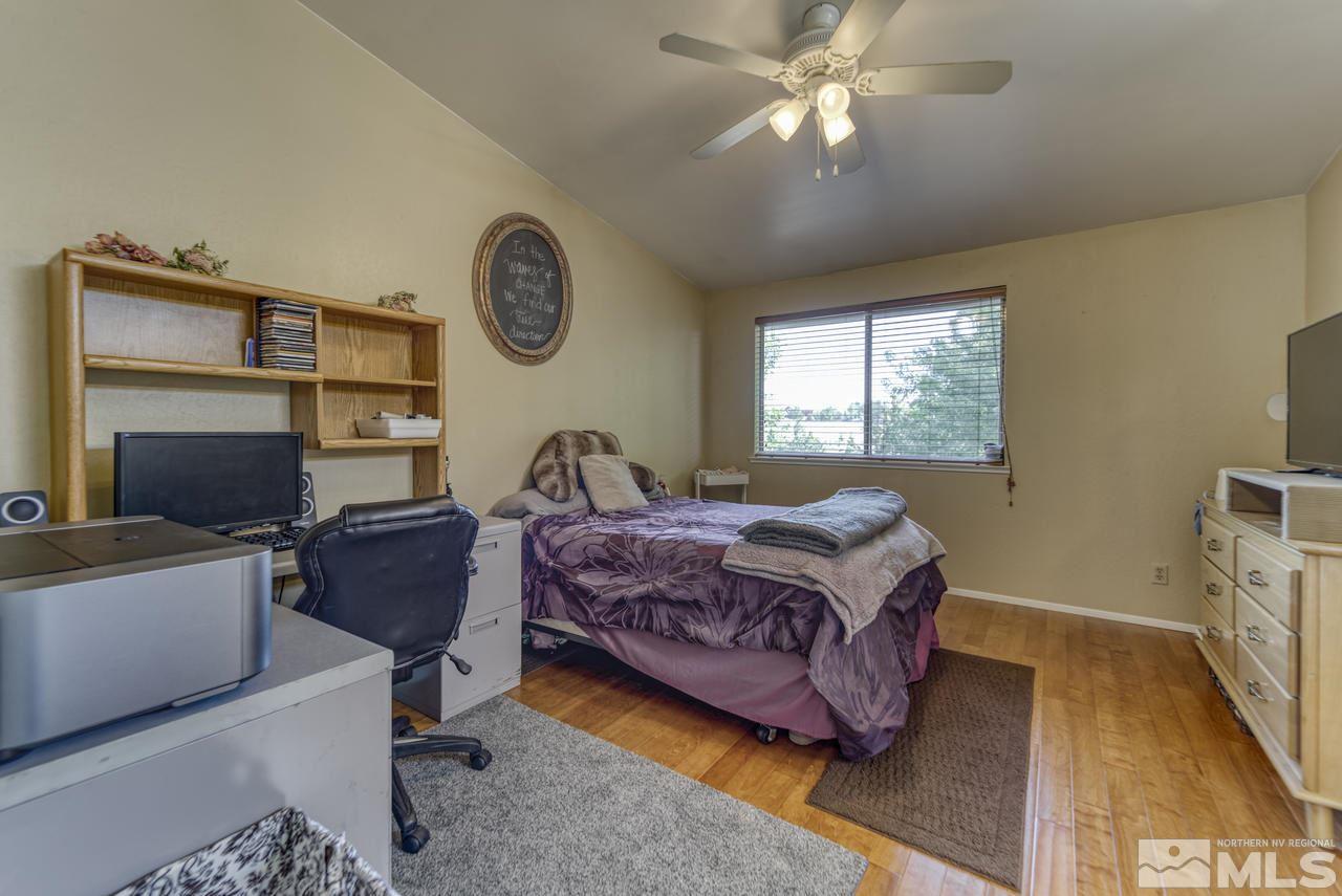 1296 Canyon Creek Road Reno, NV 89523 - Photo 31 of 32 a living room with a bed furniture a chandelier and closet