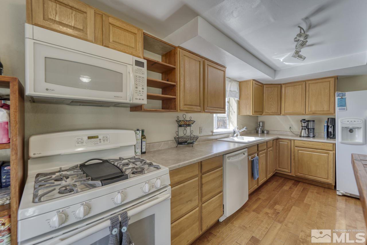 1296 Canyon Creek Road Reno, NV 89523 - Photo 9 of 32 a kitchen with a sink stove and cabinets