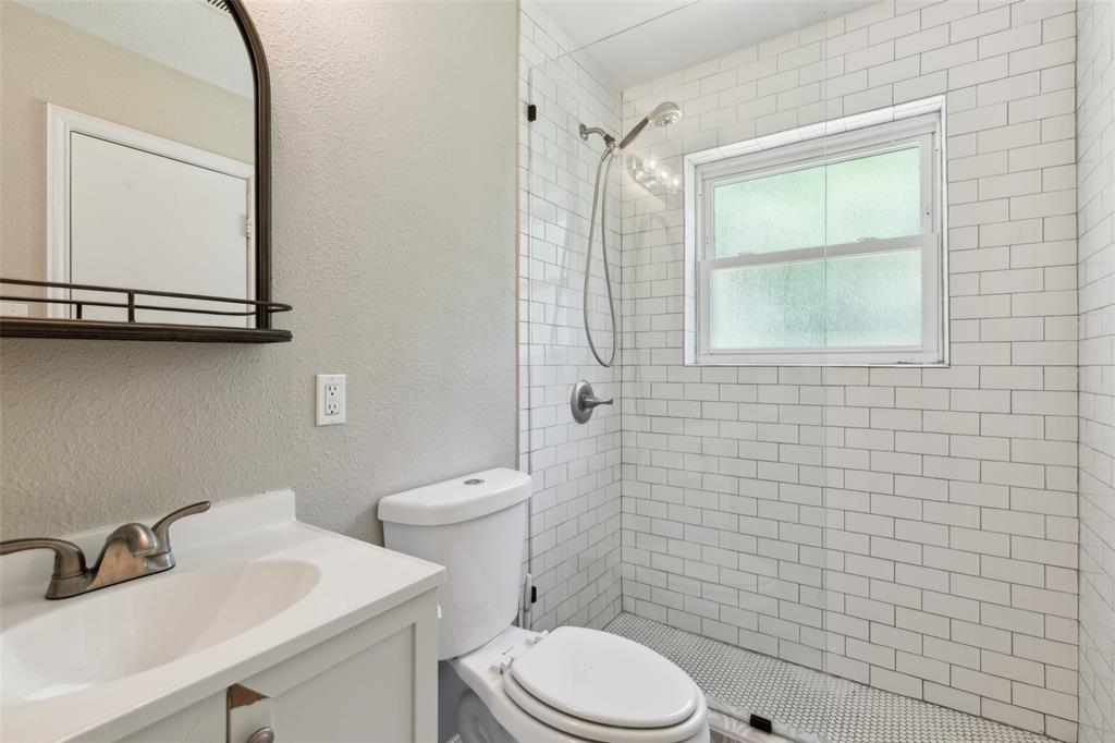 1202 Johns Drive Euless, TX 76039 - Photo 20 of 26 a bathroom with a sink a toilet and a mirror