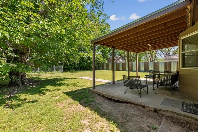 a view of a backyard with sitting area