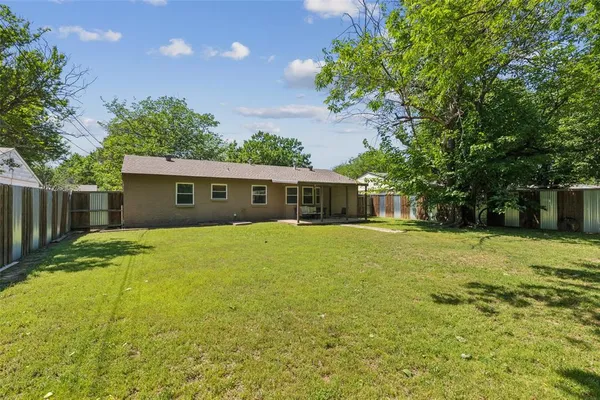 a front view of house with yard and trees