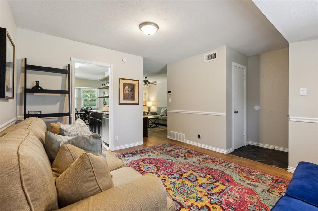 1202 Johns Drive Euless, TX 76039 - Photo 6 of 26 a living room with a couch and a dresser with wooden floor