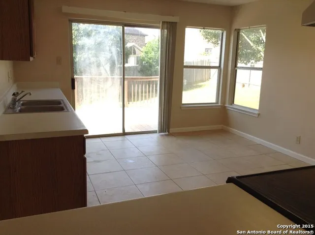 a kitchen with a sink cabinets and a stove