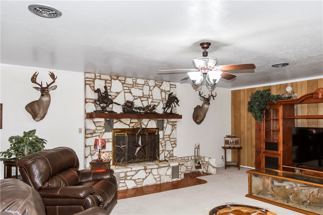 155 Harbor Circle Mathis, TX 78368 - Photo 22 of 40 a living room with fireplace furniture and a chandelier