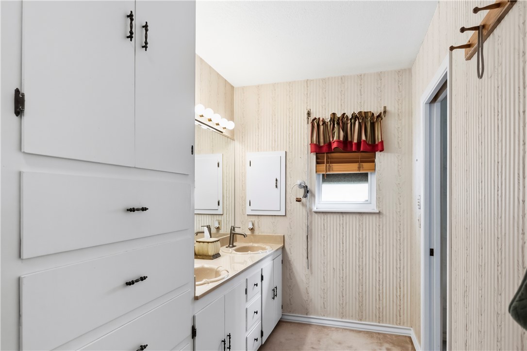 155 Harbor Circle Mathis, TX 78368 - Photo 27 of 40 a bathroom with a double vanity sink a mirror and shower